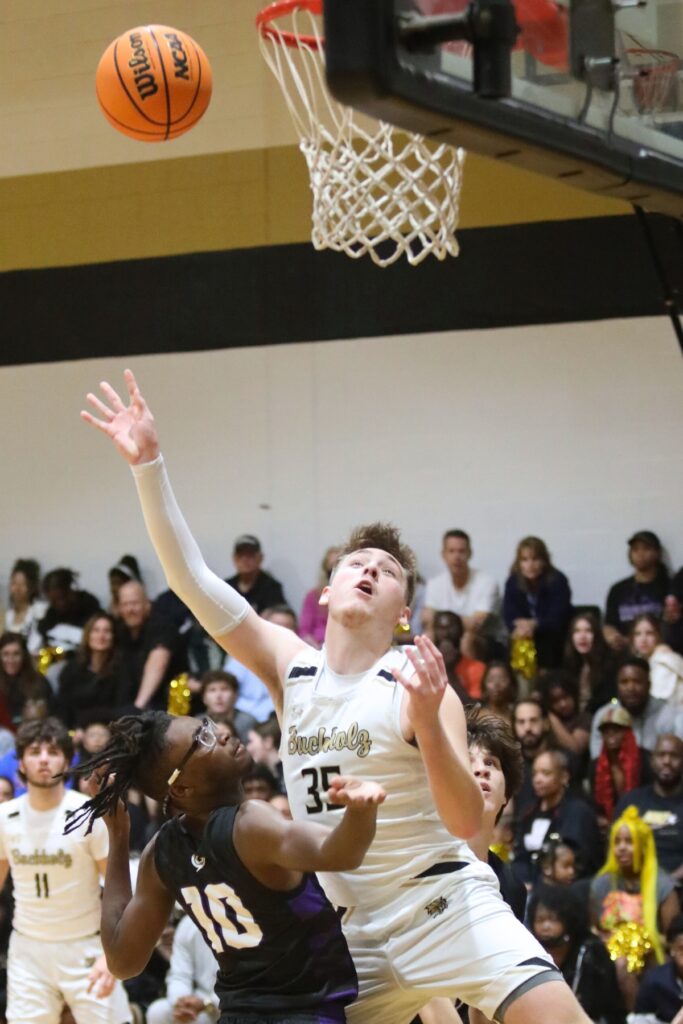 Buchholz's Palmer Walton makes a bakset over Gainesville's Jordan Dixon.