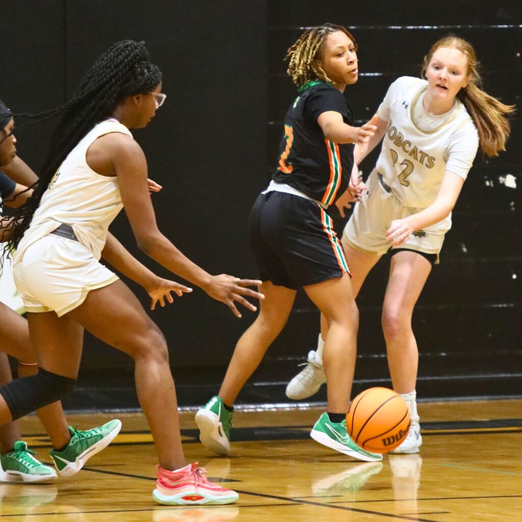 Buchholz's Sarah Collins (22) with a pass to teammate Tionna Wilkinson around Eastside's Aniya West.