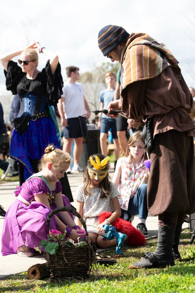 Children watch a puppet dance.