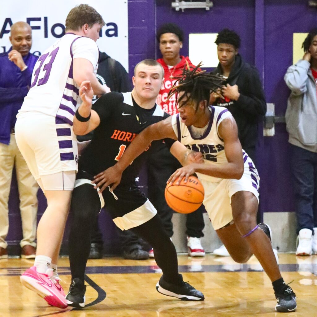 Gainesville's Cornelius White dribbles around Hawthorne's Andrew Zock.