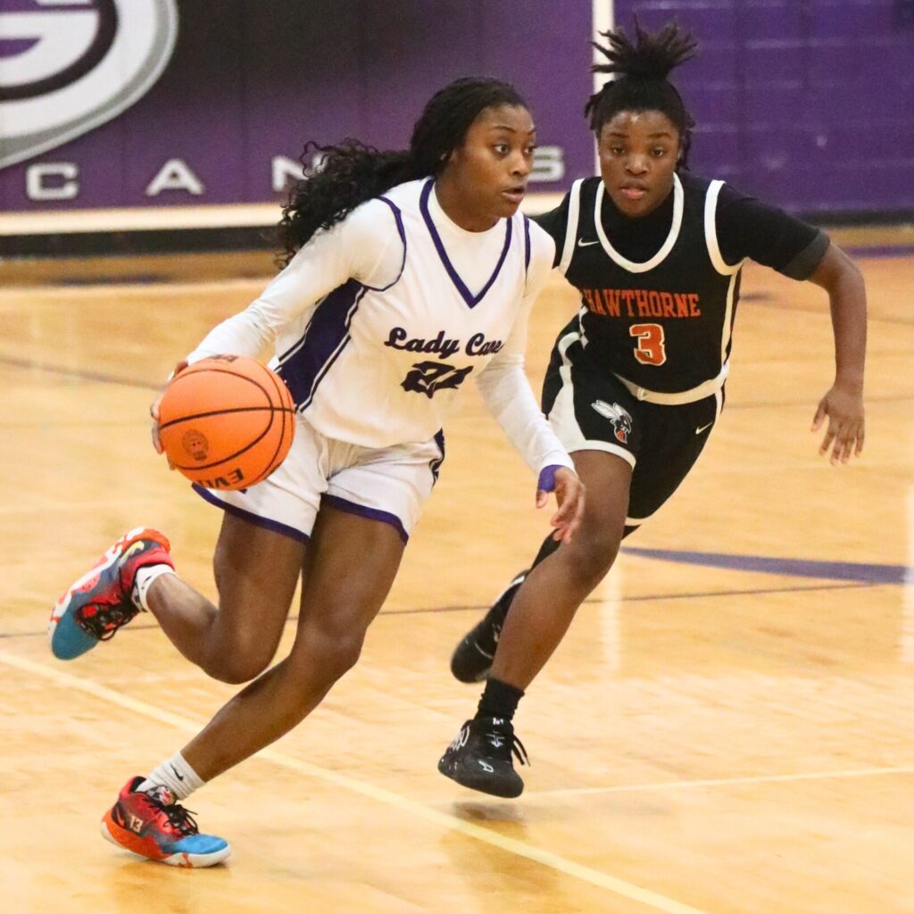 Gainesville's Jocelyn Wallace drives past Hawthorne's Lakijah Brown.