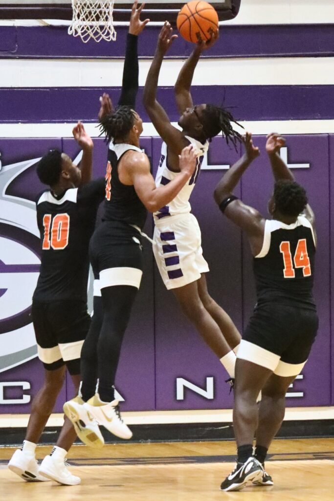 Gainesville's Jordan Dixon goes for a shot against Hawthorne's Leland Johnson.