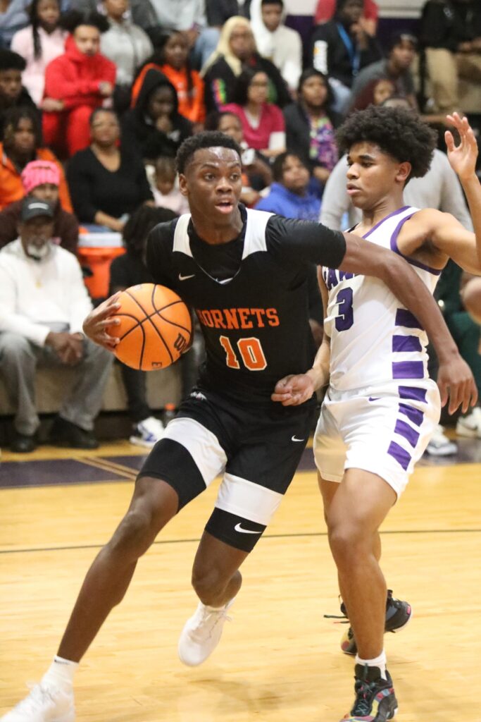 Hawthorne's C.J. Ingram dribbles around Gainesville's Jacob Wright.