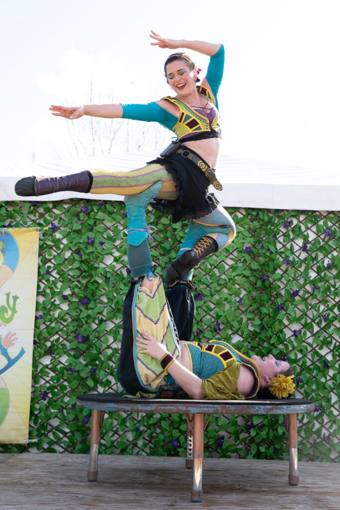 Lily LaBelle balances atop the feet of Amanda Renaud. The women comprise the Topsy Turvy “sisters.”