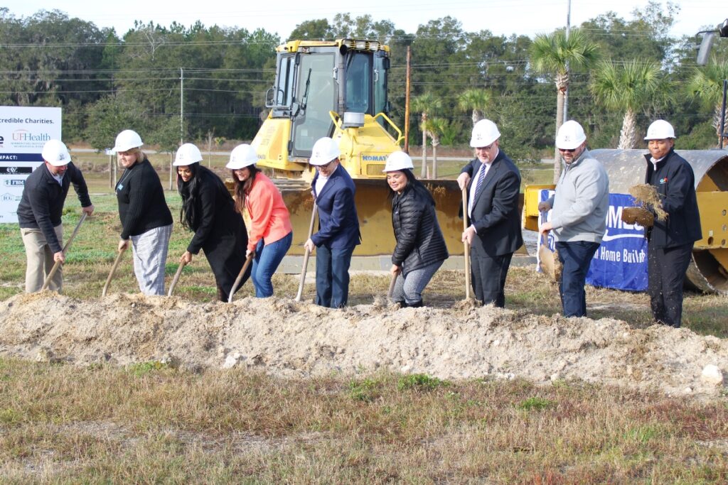 Nonprofit leaders, ICI Homes employees and community leaders break ground on the home site.