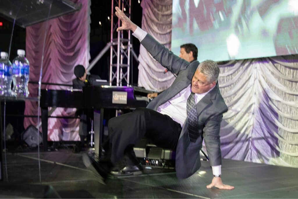 Outgoing chamber chair Domenic Scorpio shows off his breakdancing moves before delivering his speech.