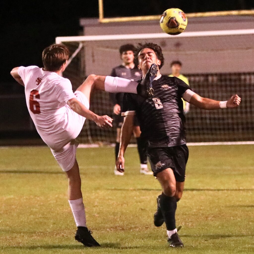 Santa Fe's Clayton Morgan with a kick against Buchholz's Deva Spradling.