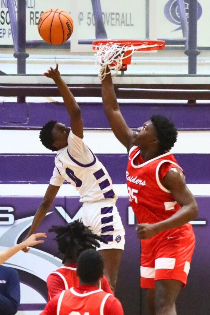Santa Fe's Jamarian Foye attempts to block a shot by Gainesville's Brian Smith.