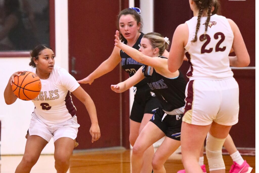 St. Francis Catholic's Natalia Winans (20) and Tommie Bost (4) defend Oak Hall's Lunden Warmack.
