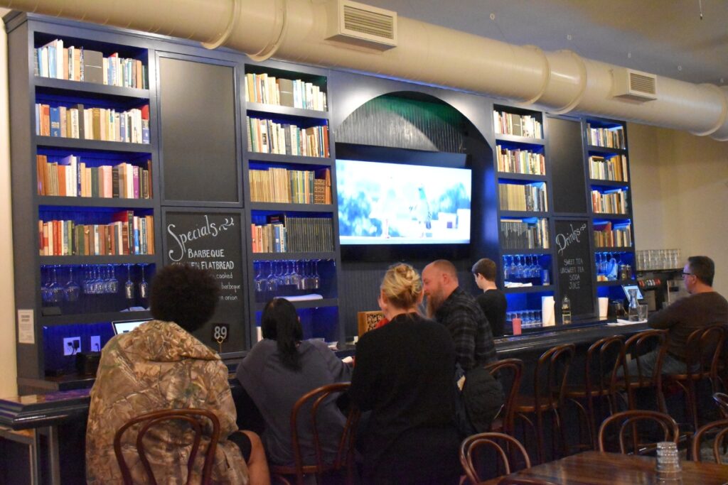 The long counter at Capricious sits in front of books taken from Rummel's grandparents' library.