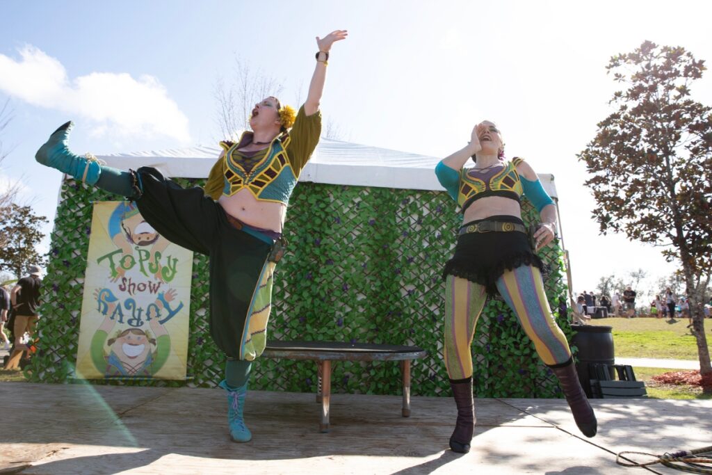 Topsy Turvy performers Amanda Renaud, left, and Lily LaBelle attract an audience before their show.