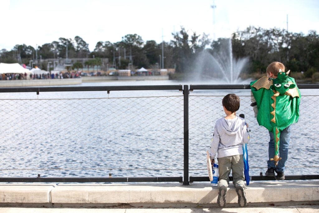 Two boys observe the Depot Park pond.
