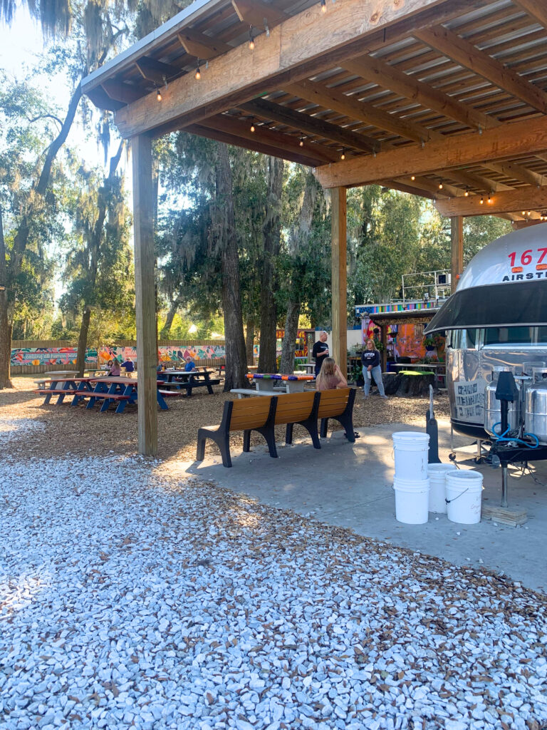 The outdoor seating area at 4th Ave Food Park and the Opus Coffee Airstream.