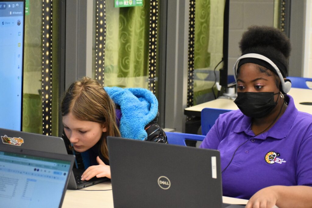 Ash Wade (left) and Takayla Smith work on a script for their scene recreation.