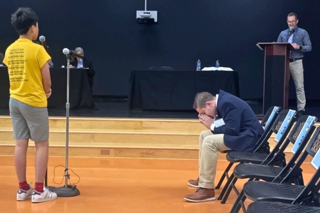 Cooper Campen prays before his final word at the district spelling bee.
