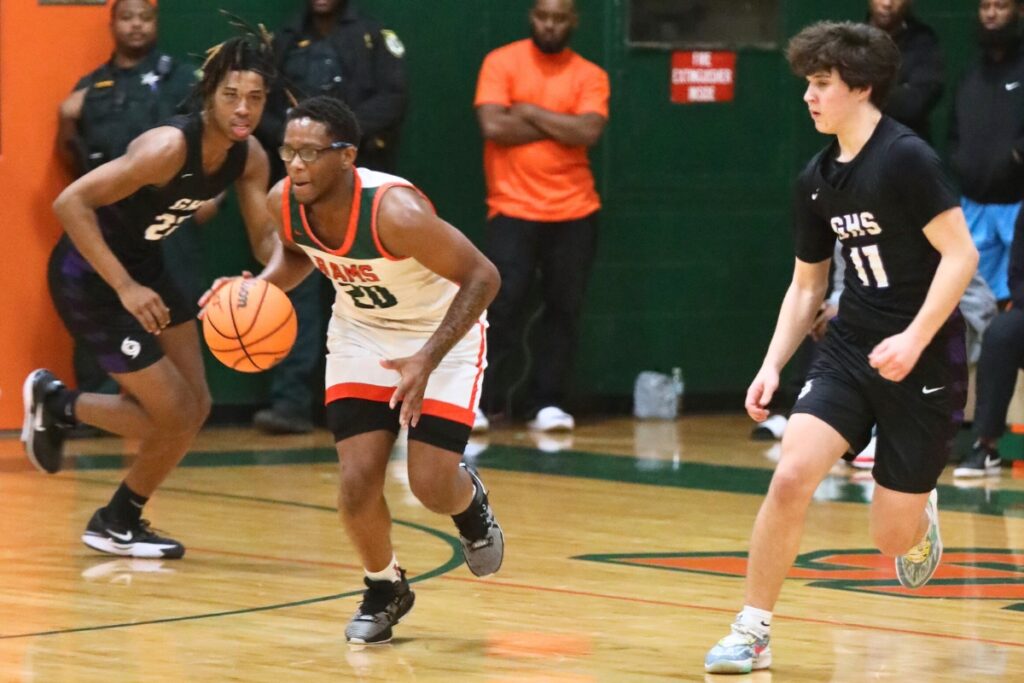 Eastside's Dante Bray brings the ball down the court against Gainesville's Simon Childers (11).