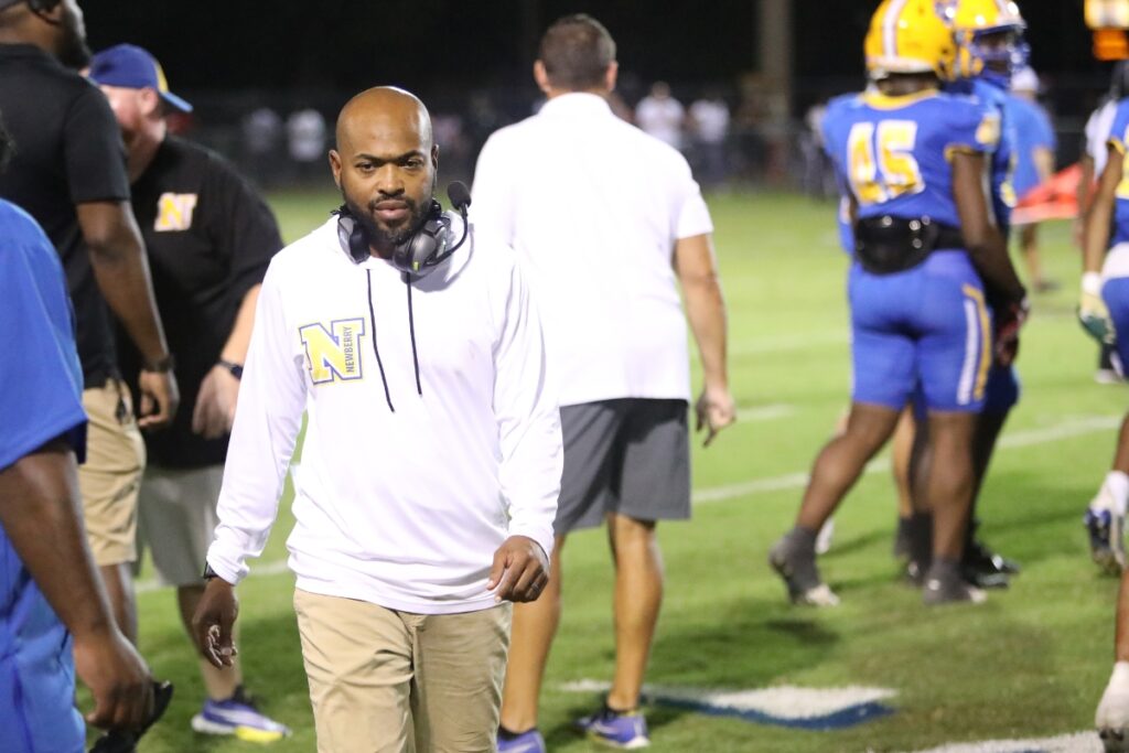 Ed Johnson (with headset) was reinstated as the Newberry head football coach on Wednesday after being dismissed on Tuesday.