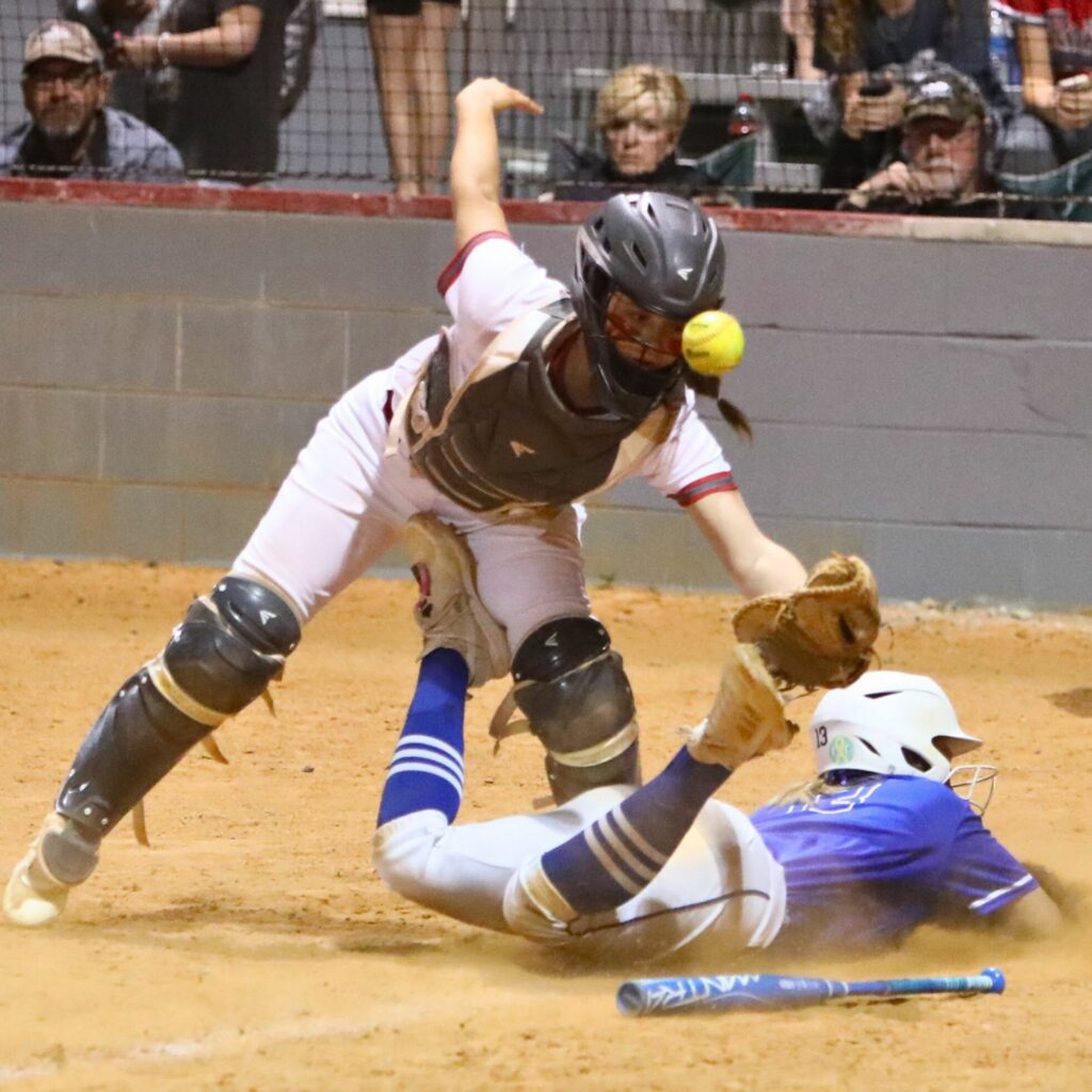 Keystone Heights Abbie Roach beats the throw home to Santa Fe's Ainslea Kelsoe to put the Indians ahead 7-5 in the top of the sixth inning.