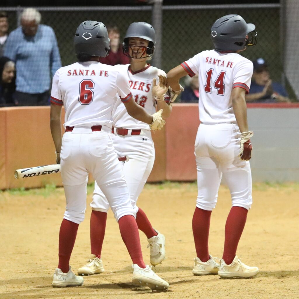 Santa Fe's Madisen Crosby (6) celebrates with Gracie Mattson (12) who hit a two-run walkoff single in the bottom of the seventh inning that drove in Madisen and Amy Crosby for an 8-7 win over Keystone Heights.