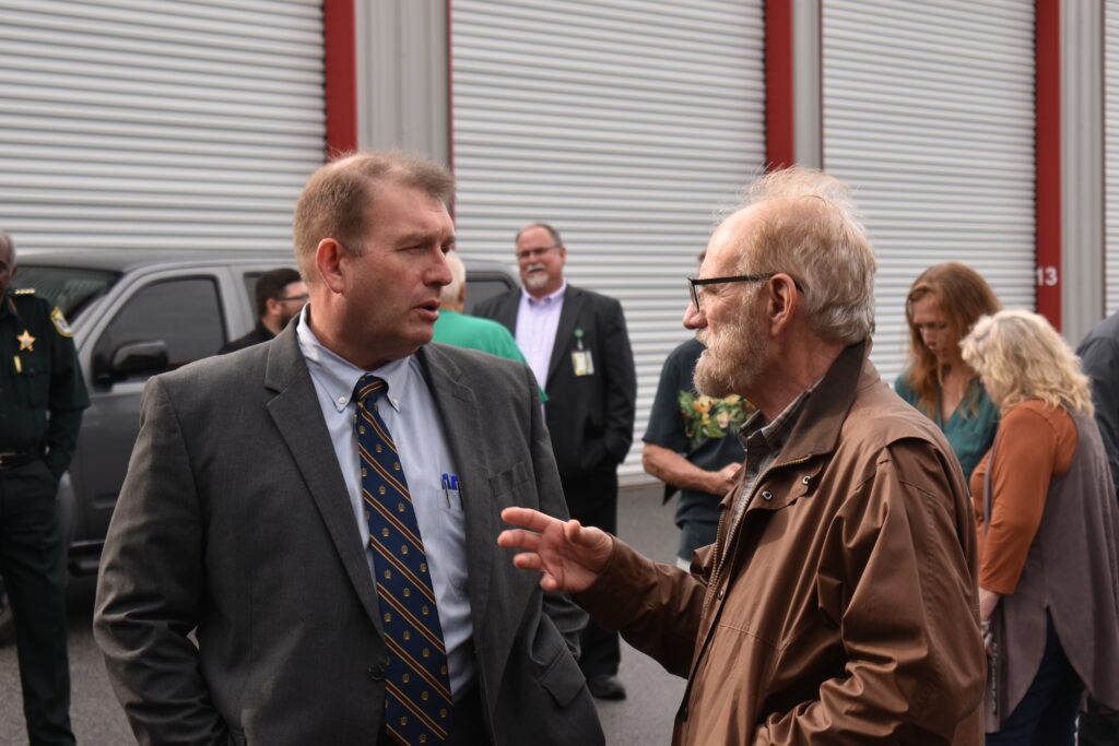 State Attorney Brian Kramer speaks with a resident at Wednesday's event. 