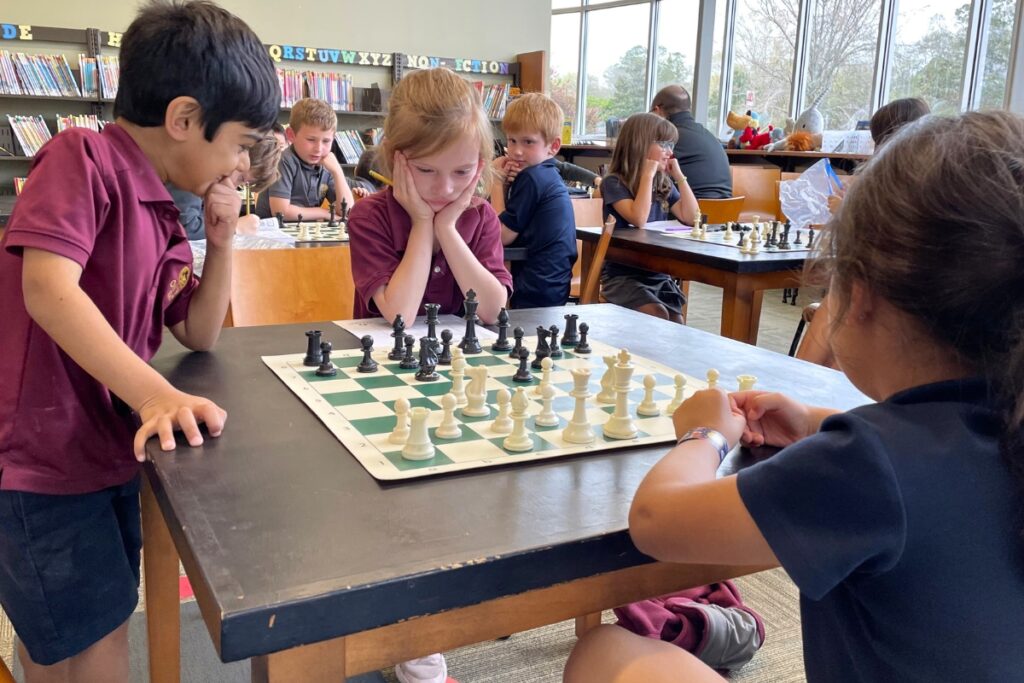 Suraj Jani, left, watches on as Olivia McLellan thinks about next moves in her chess match.