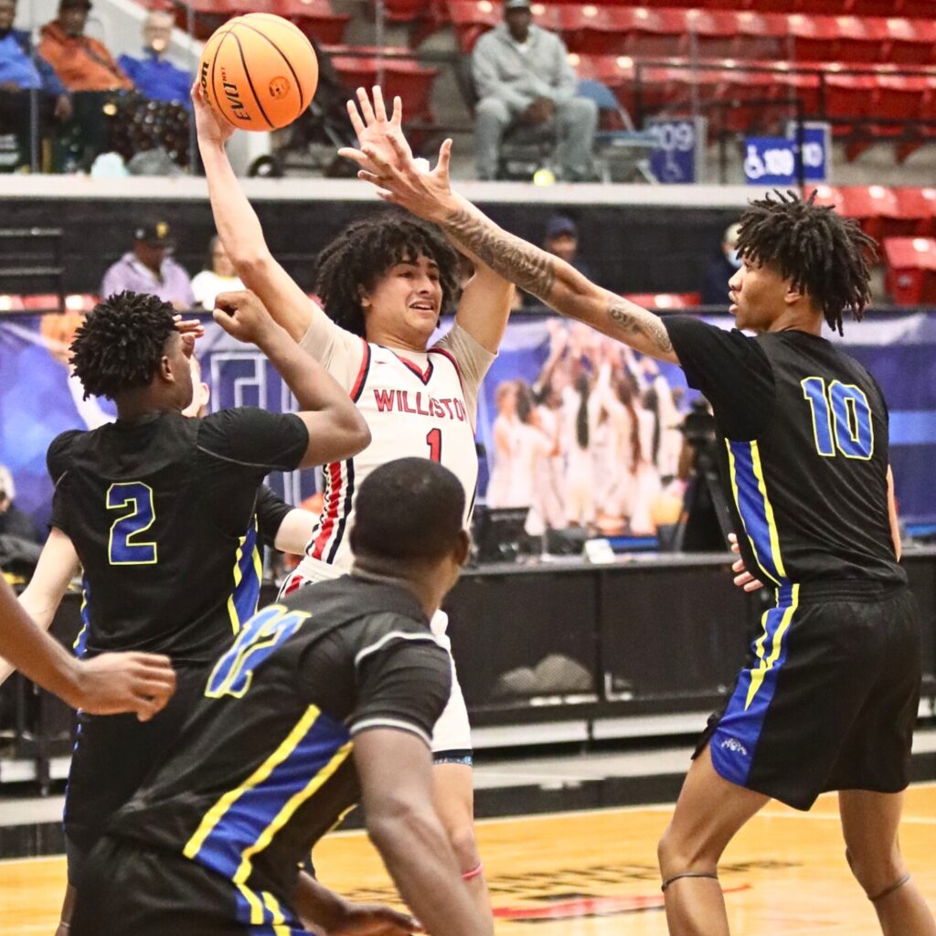 Williston's Aramys Rodriguez makes a pass out of a group of Chipley defenders in the Class 1A State Semifinal game at FP Funding Center in Lakeland.