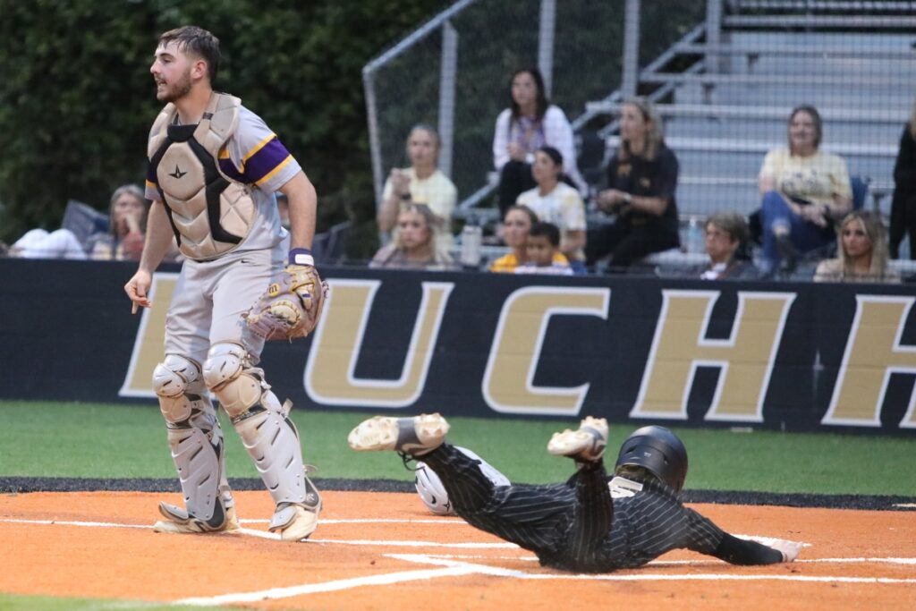 Buchholz's Hudson Sapp slides home safely to give the Bobcats a 1-0 lead in the bottom of the second inning against Columbia.