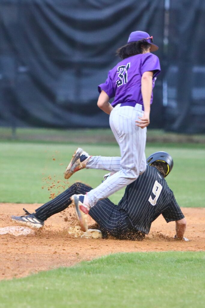 Buchholz's Noah Hayse (9) steals second base in the bottom of the first inning against Gainesville's Anthony Dang.