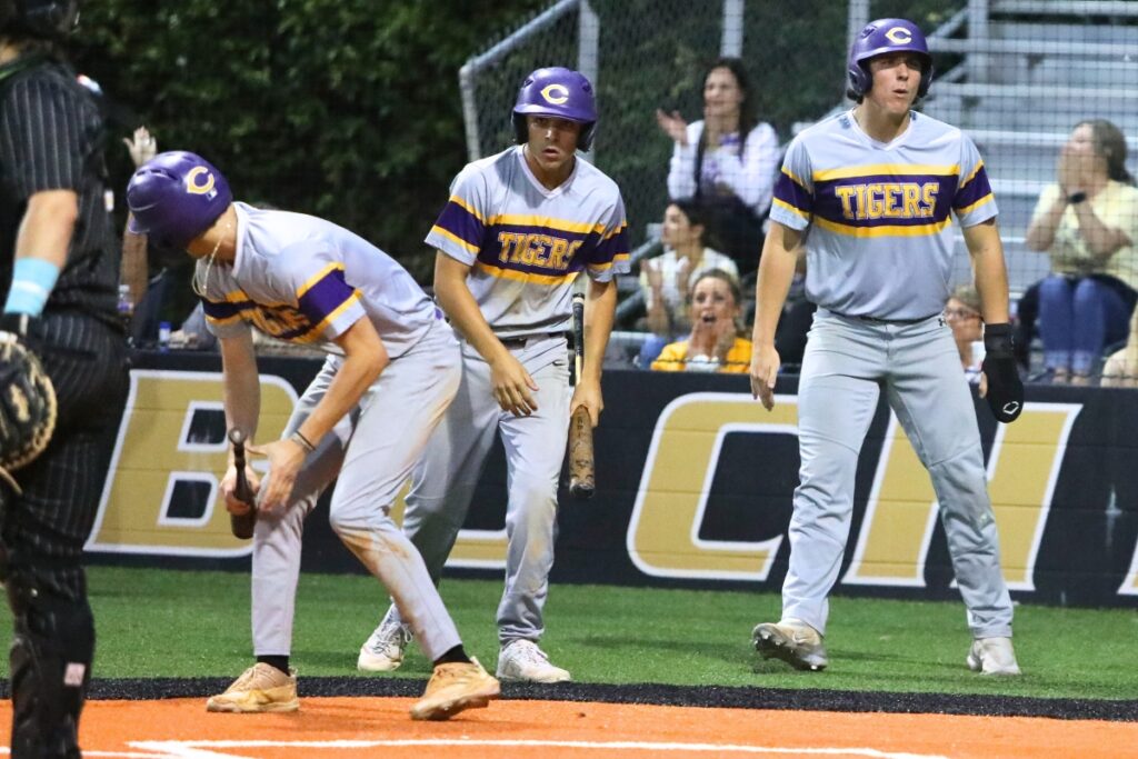 Columbia's Ayden Phillips (right) celebrates after scoring against Buchholz to put the Tigers ahead 2-1 in the top of the third inning.