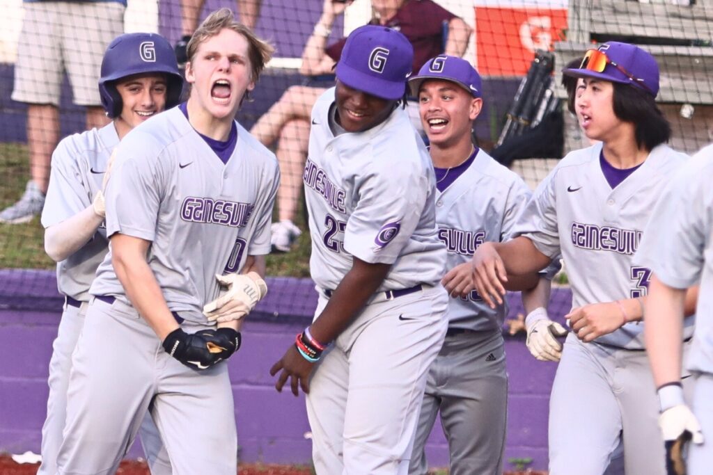 Gainesville's Connor Kemph (second from left) celebrates with teammates after hitting a three-run home run against Oak Hall in the top of the third inning.