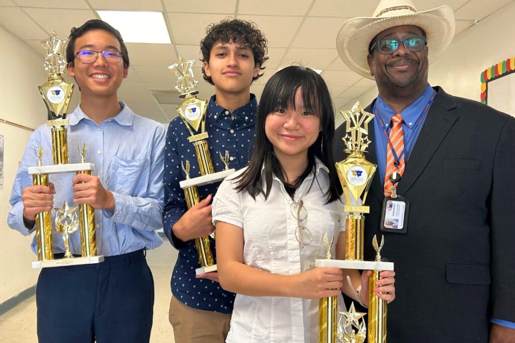 Lincoln Middle School first-place winners at the FSDI competition include (from left) (l-r) Michael Huan, Joel Cardenas and Maggie Gao and coach Marna Weston.