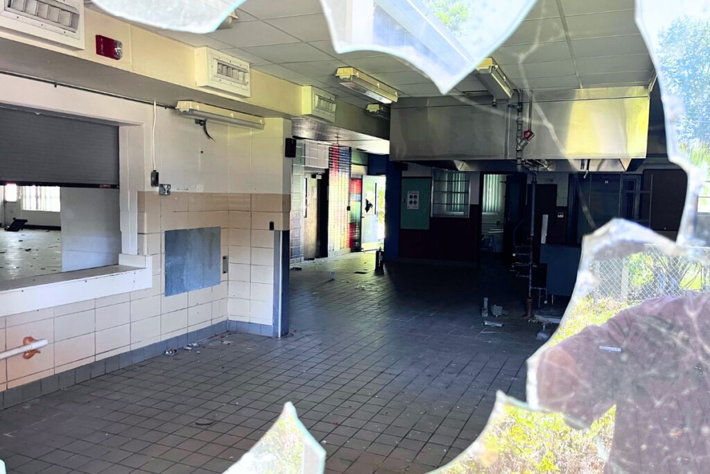Looking through a broken window at the old Terwilliger Elementary School campus on NW 62nd Street in Gainesville.