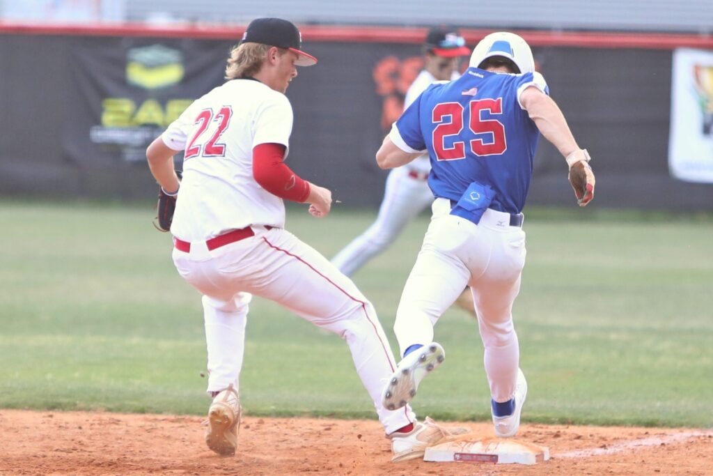 Santa Fe pitcher Caleb Kietzman (22) gets Keystone Heights' Kenneth Guy (25) out at first base in the top of the third inning.