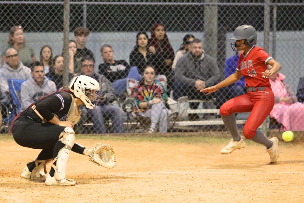 Santa Fe's Amy Crosby beats the throw home to Gainesville catcher Braylin Cook in the top of the fifth inning.