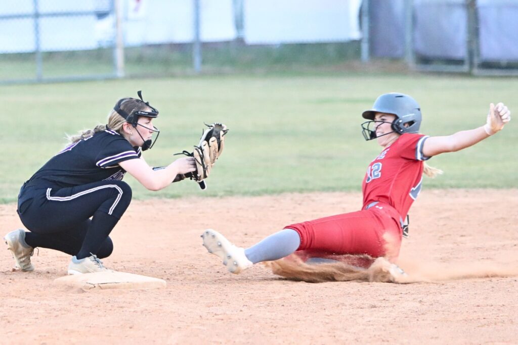 Santa Fe's Gracie Mattson slides safely into second base in front of Gainesville's Roxanne Walsh in the third inning.