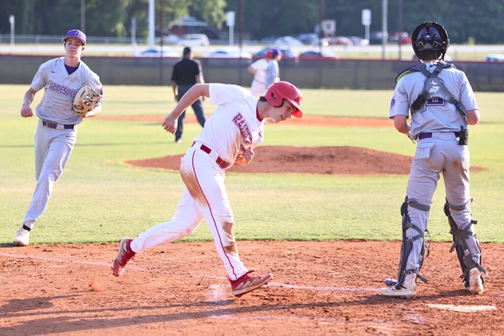 Santa Fe's Jackson Ruppert scores in the first inning against Gainesville to put the Raiders up 4-0.