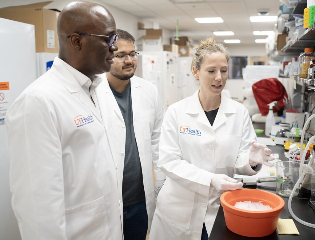 Dr. Duane Mitchell, Jeet Patel and Dr. Christina von Roemeling in the Adam Michael Rosen Neuro-oncology Laboratories.
