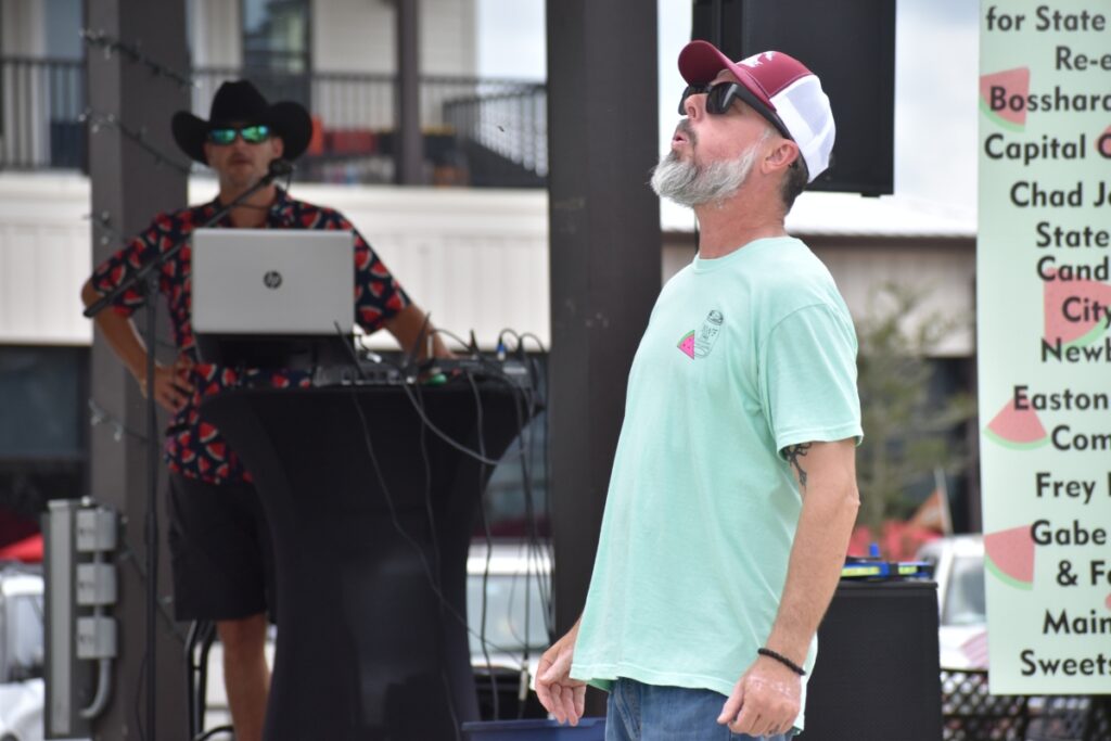 Newberry Mayor Jordan Marlowe kicks off the watermelon festival with the first seed spit.