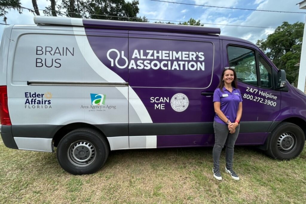 Heike Accorsi, bilingual program manager for the Alzheimer Association’s Brain Bus, stands outside her vehicle at a recent event.