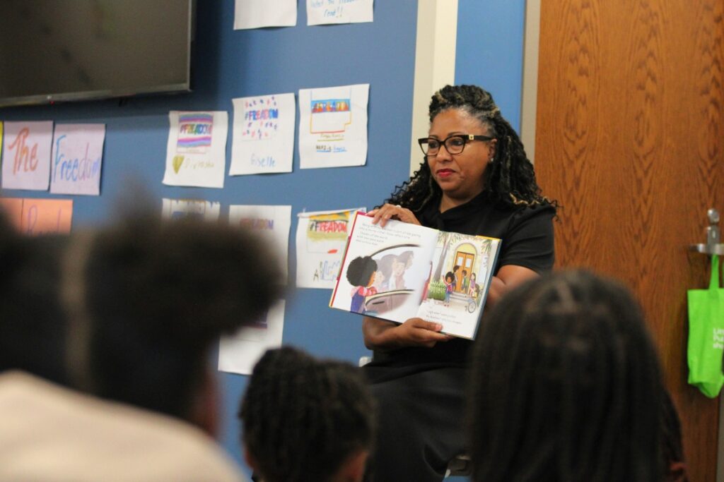 Alachua County Judge Meshon T. Rawls reads to the scholars.