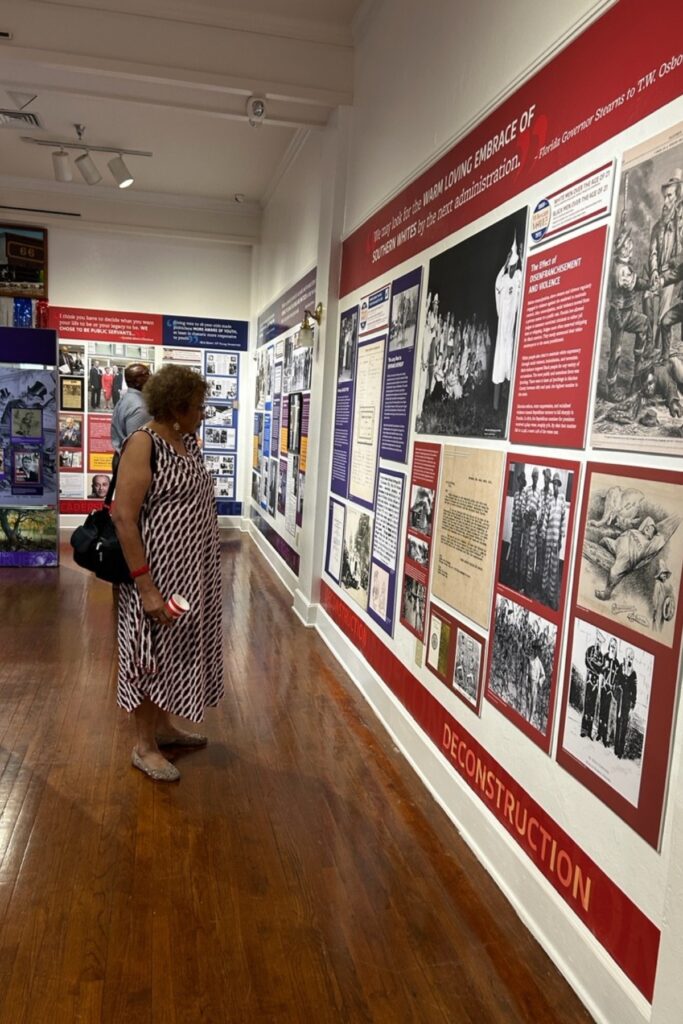 Barbara McDade Gordon, a professor emeritus at the University of Florida and a member of the Cotton Club Museum and Cultural Center board of directors, views the exhibit.