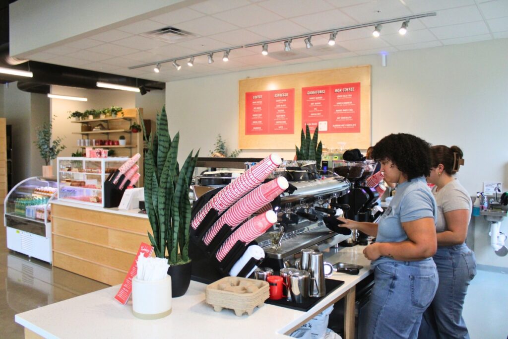 Cierra Beard and Geneva Smallwood prepare coffee behind the bar.
