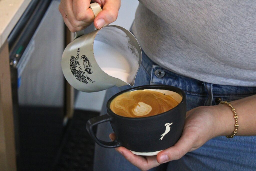 Cierra Beard pours steamed milk into a latte at the Kookaburra.
