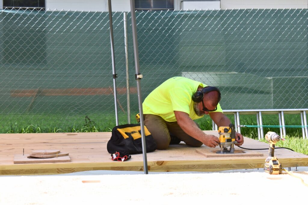 Daniel Wirth prepares a roof panel for support posts.