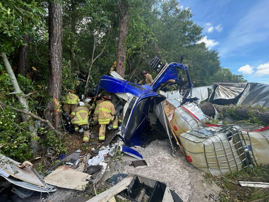 Crews work to free an entrapped truck driver.
