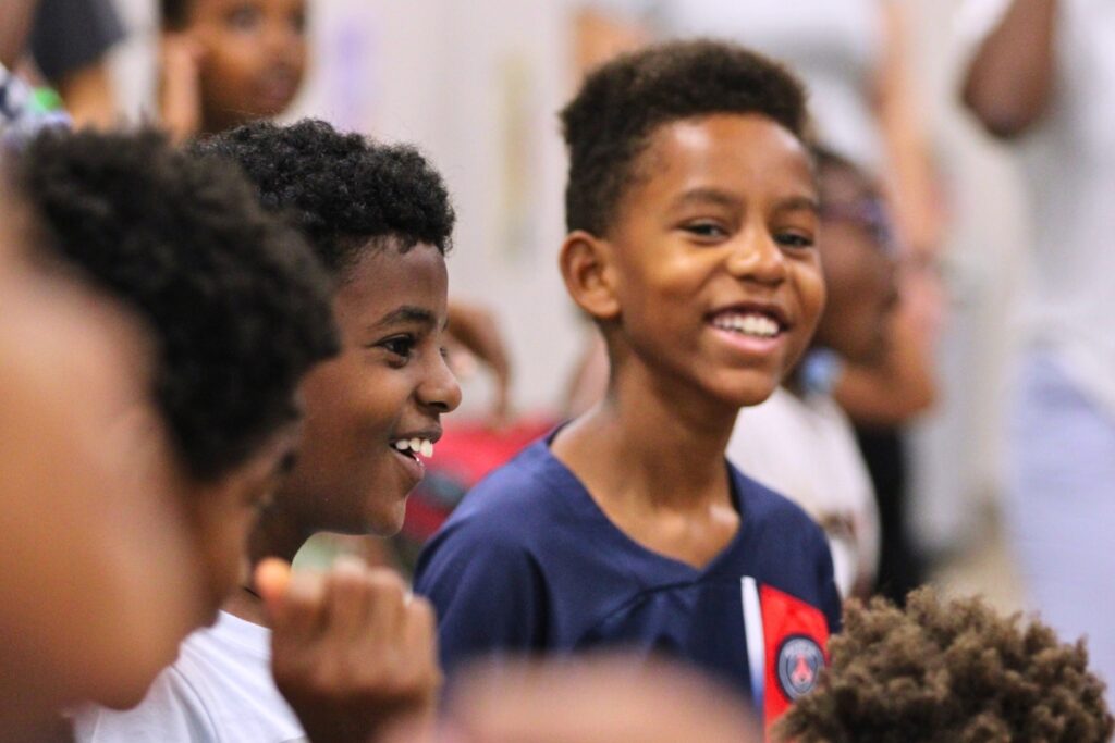 Isiah Odera shouts out as part of the morning Harambee.