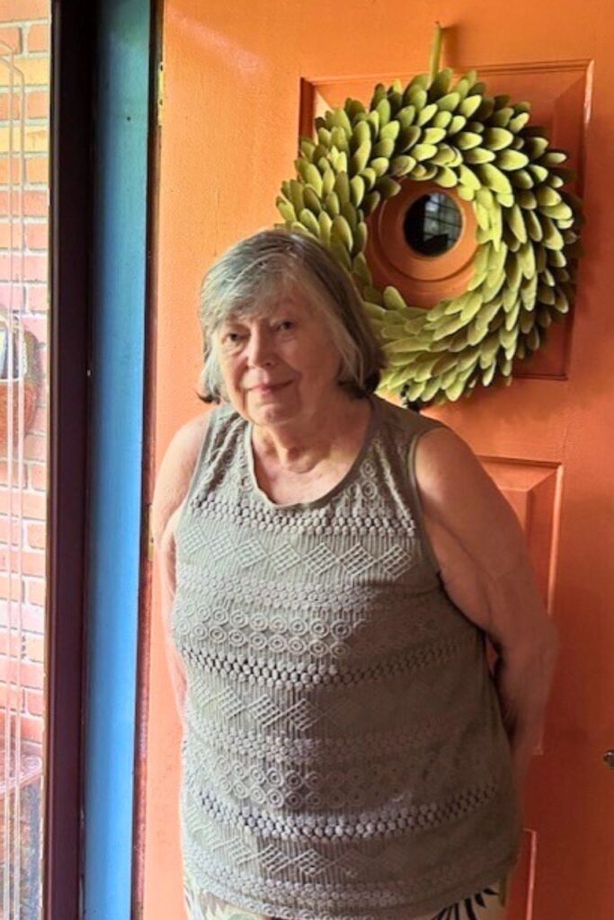 Julie Gray Burns in front of her home.