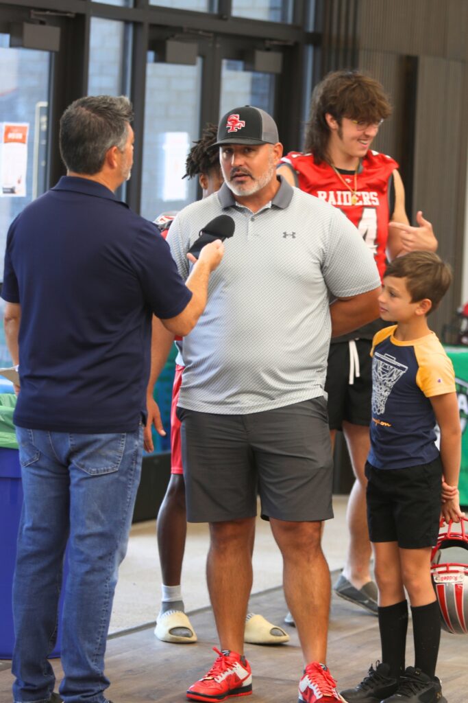 Mainstreet Sports Director Mike Ridaught interviews Santa Fe coach Jason Wells at the 2024 North Central High School Media Day on Wednesday.