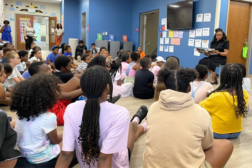 Scholars listen to Judge Meshon T. Rawls read a book to start the morning, a daily routine.