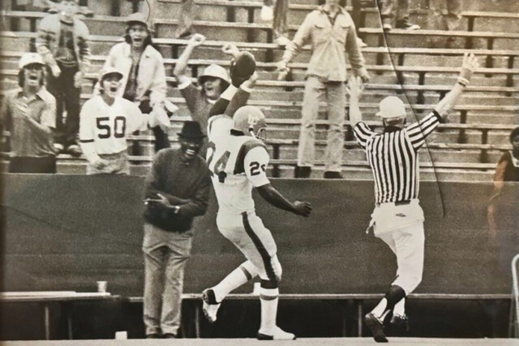 UF safety Wayne Fields, an all-time Gator great, returns an interception for a touchdown during a 17-6 victory over Miami in 1972. In the stands, Robbie Andreu has his arms raised in the air. His brotherTim is in the #50 jersey. Standing directly behind Tim Andreu is Pat Dooley. And on the far left is Tim Dooley. The Gators finished the season with a 5-5-1 record.